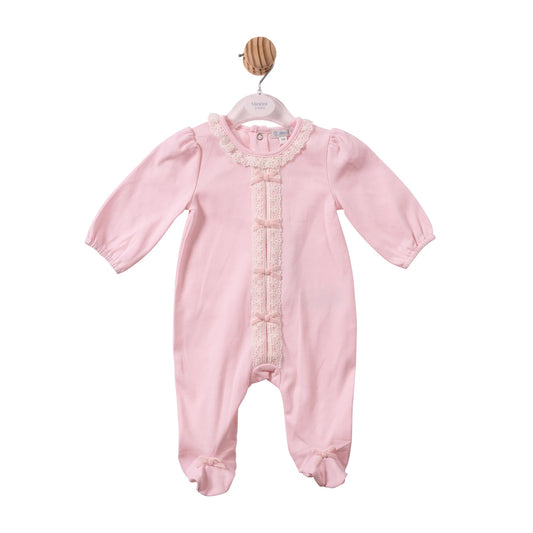 A light pink baby footed sleeper with long sleeves, a lace-trimmed round neckline, and decorative lace down the front